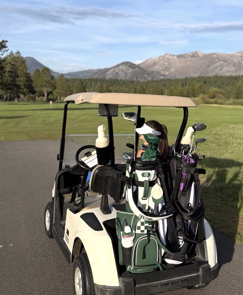 Golf cart loaded with clubs, mountain view
