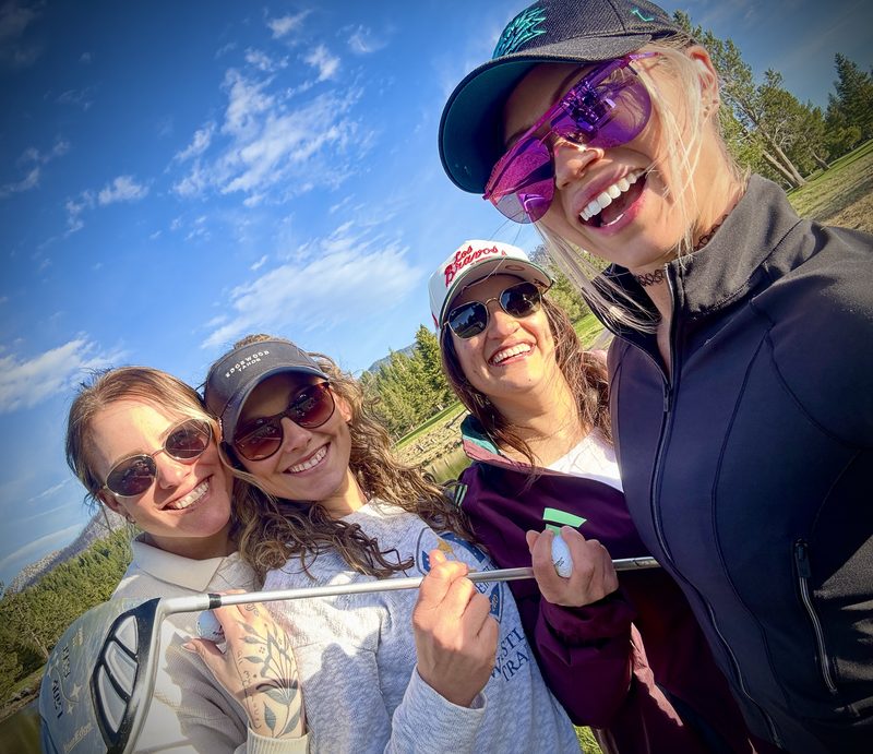 Group selfie of four members on the course