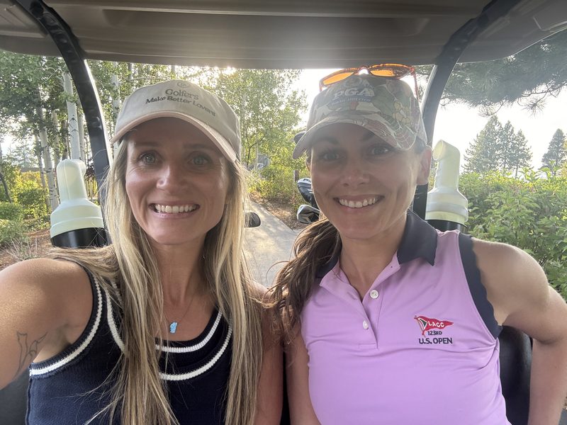 Two members in a cart at Edgewood