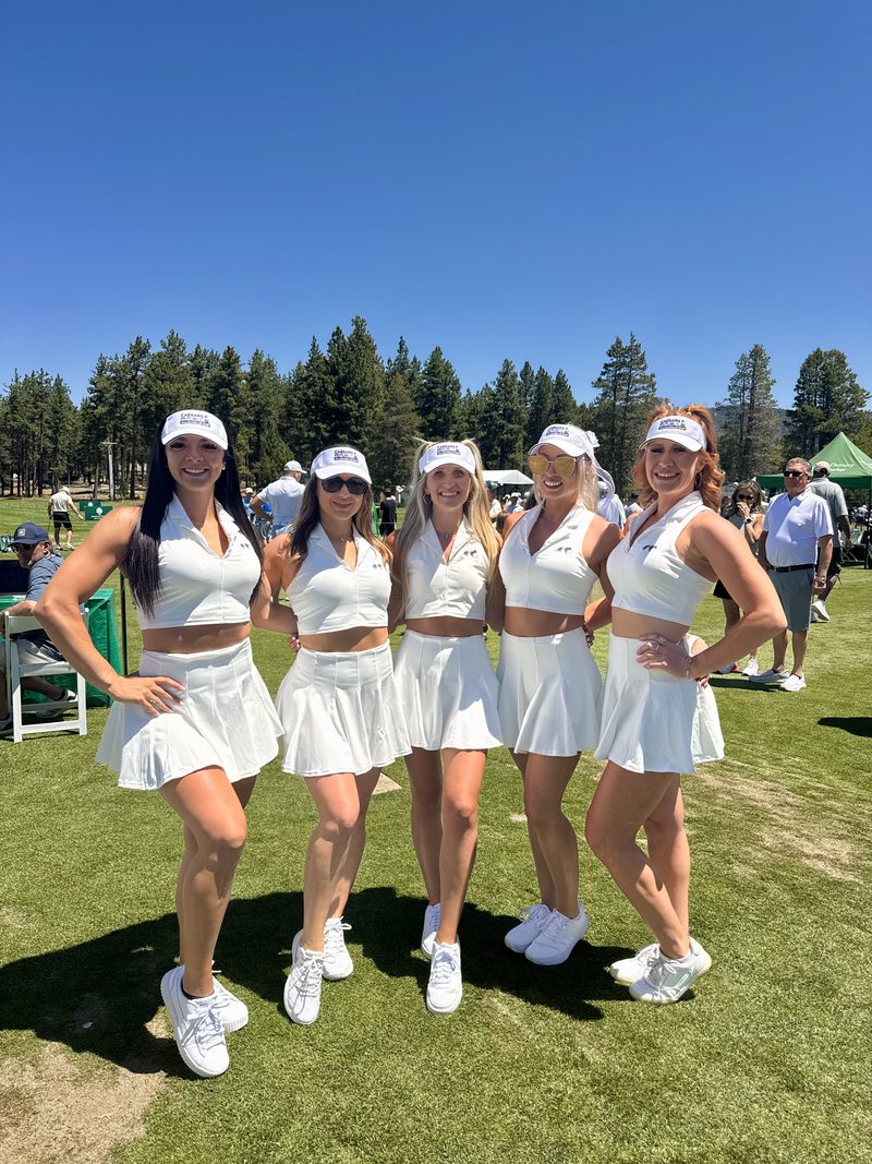 Five members in white on the course