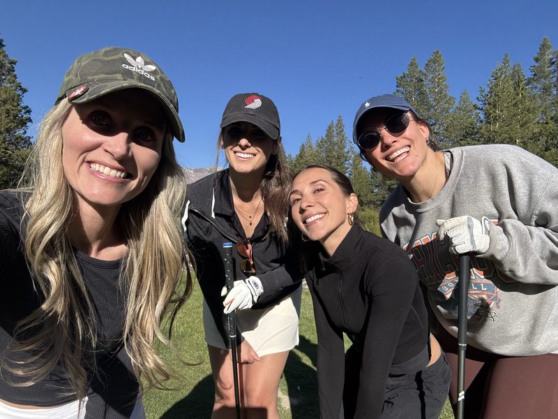 Foursome smiling on the fairway