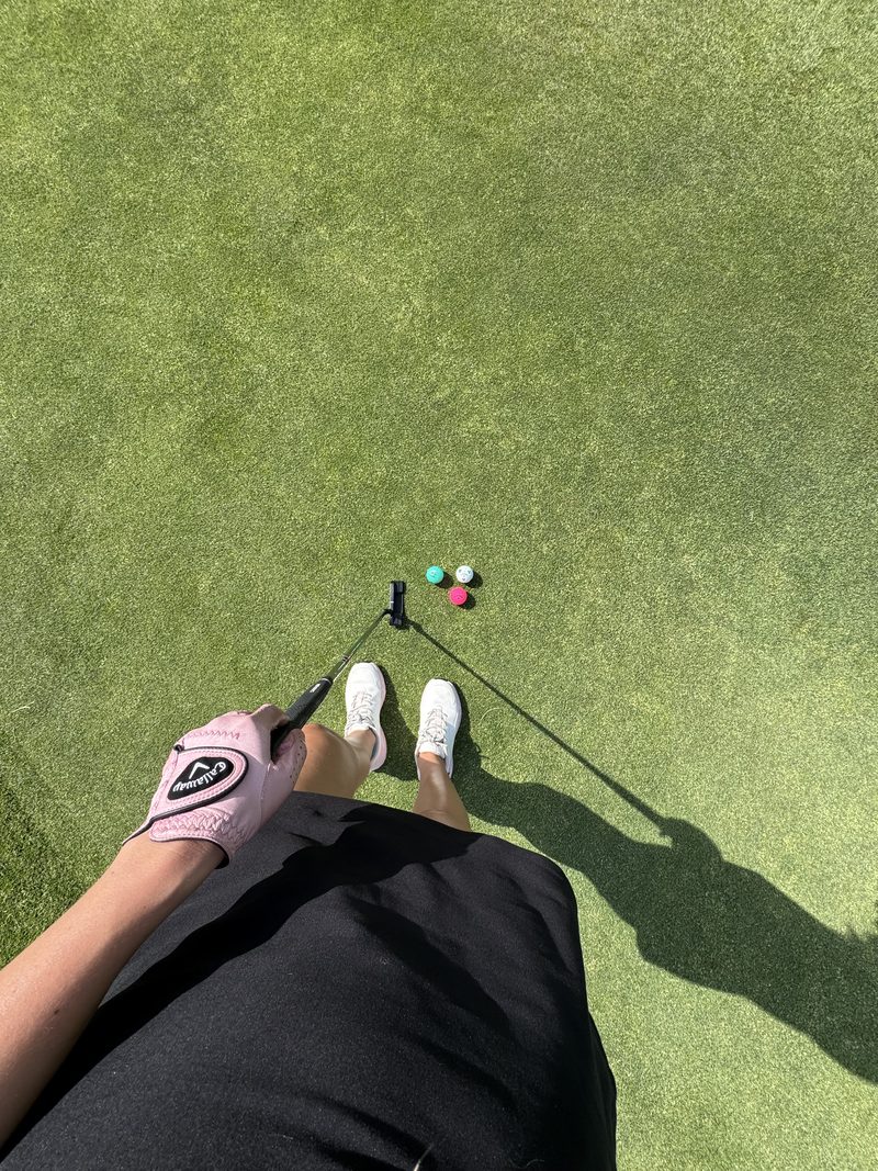 Putting line up with pink, green, and white balls